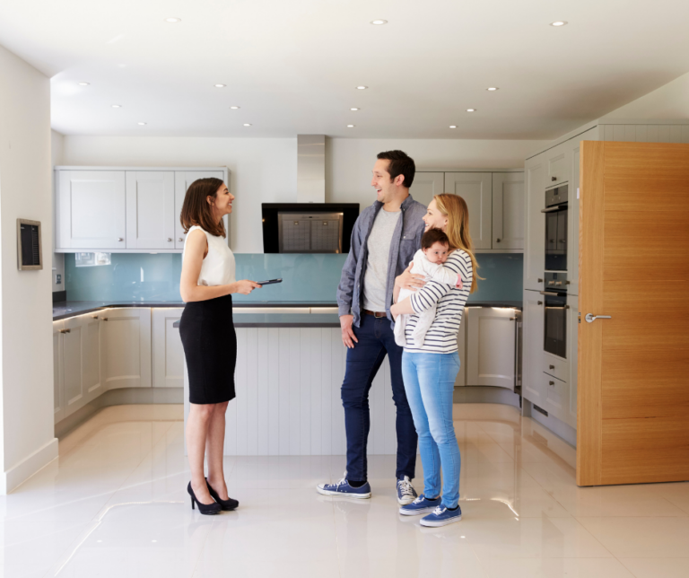 Family in the kitchen of their home talking to an insurance agent